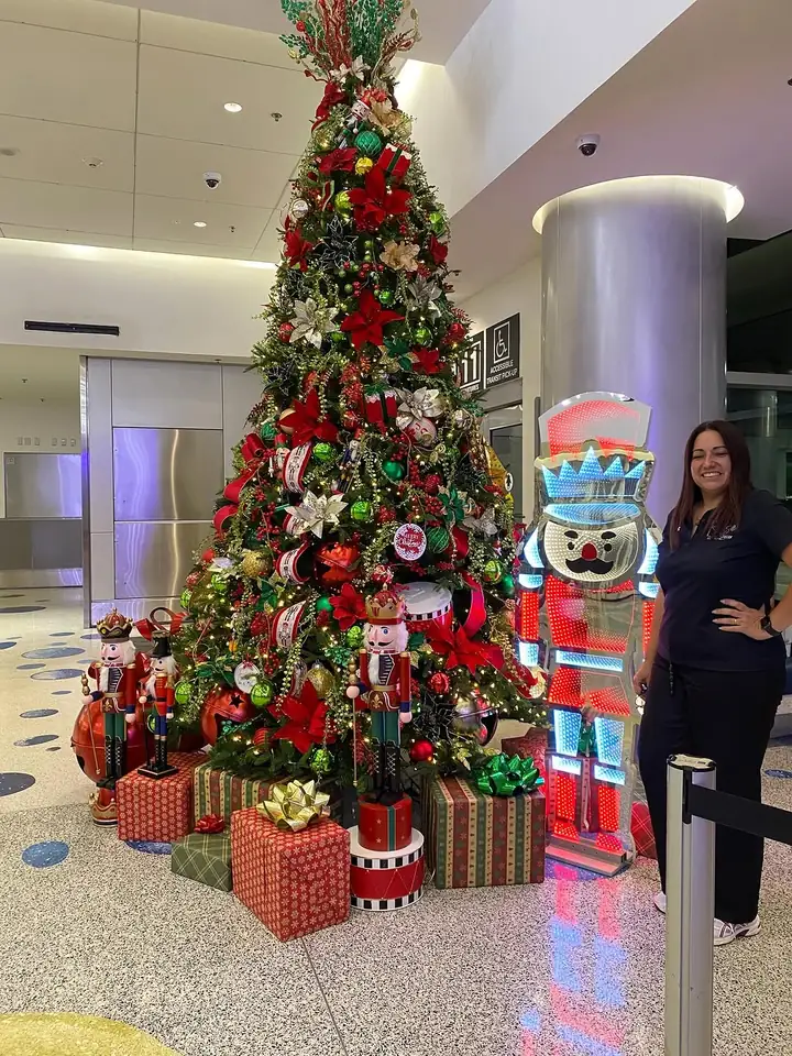 Large red and green Christmas display with a life size nutcracker in a Miami commercial lobby
