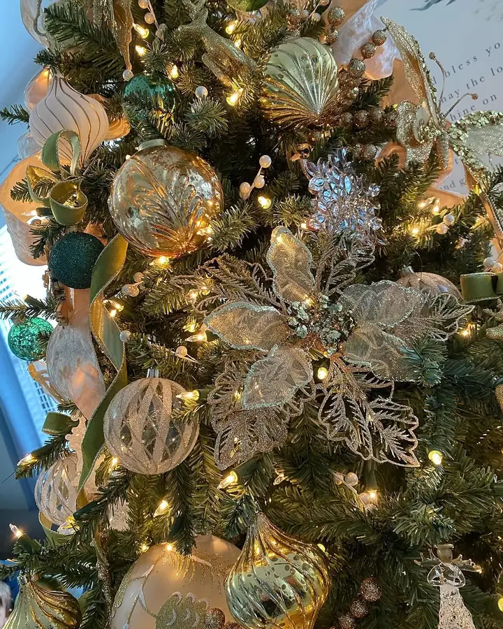 Red poinsettias clustered with gold glass on a Miami Christmas tree