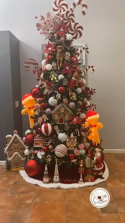 Gingerbread and candy cane themed tree with houses at the base