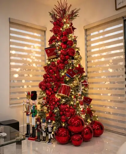 Red nutcracker themed Christmas tree with drums and oversized baubles